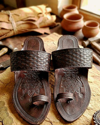 Aarambh in deep brown on a wooden table beside clay pots