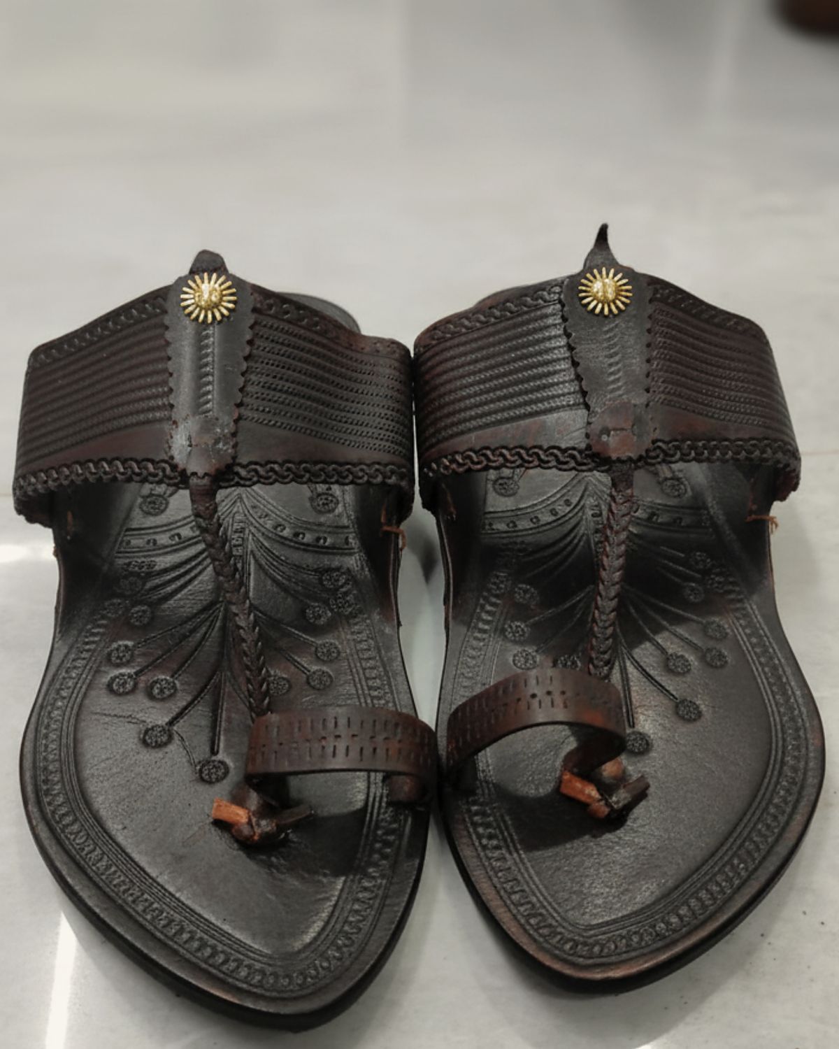 Kapshi Classic in deep brown, pair from above on a pale stone floor
