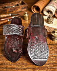 Premium Angatha Patta Kolhapuri on a teak workbench, one shoe turned to show the stamped sole